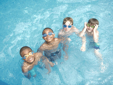 children smiling in swimming pool