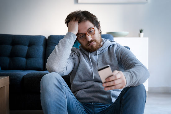 Man looking sad on phone
