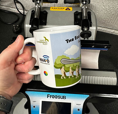 THe artwork on a printed mug coming out of the heat press