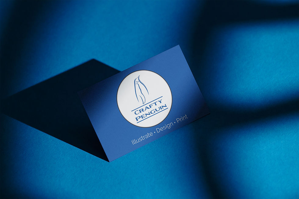 Blue business card with "Crafty Penguin" logo and text "Illustrate • Design • Print" on a blue background with shadow patterns.