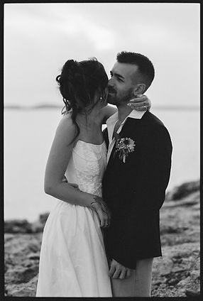 bride and groom embrace in candid moment at sunset in Ibiza