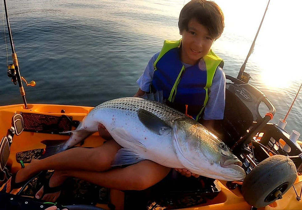 Thumbnail: A happy young client with a large striped bass almost as big as him!