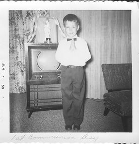 "1st communion day" written on border, "age 7" written on back, 1959.