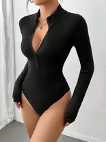 Angled view of woman in black zip-up collared bodysuit, zipper open