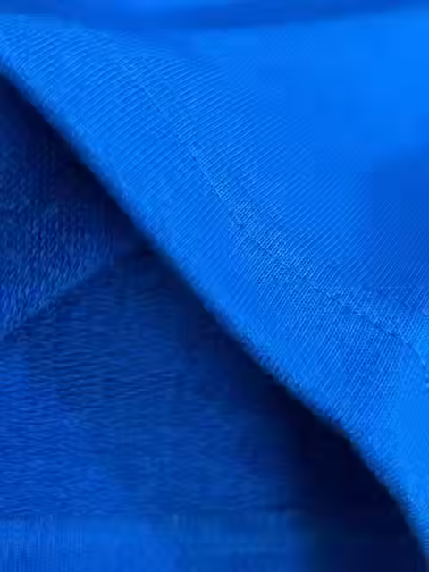 A close-up of blue boxy t-shirt from PUSHING TWENTY