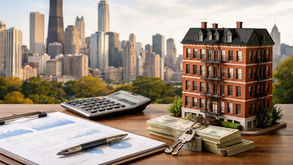Chicago skyline in the background with a model brick multifamily apartment building on a desk, alongside financial documents, calculator, cash stack, and keys representing multifamily property financing in Chicago.