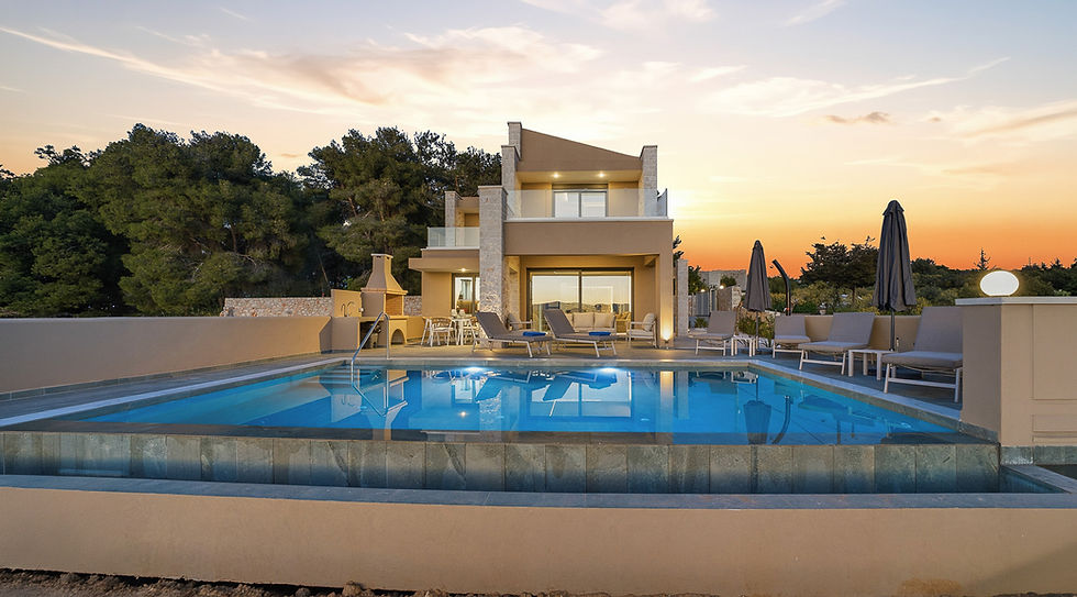 Modern villa with a pool at sunset, surrounded by trees. Lounge chairs and umbrellas by the water, creating a serene, luxurious ambiance.
