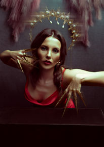 women portrait who is wearing red dress and golden crown at vilija skubute photography studio