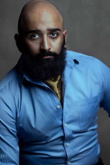 man in a blue t-shirt headshot