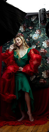behind the scene women portrait dressed in green dress and red sleeves at vilija skubute photography studio, Manchester, UK
