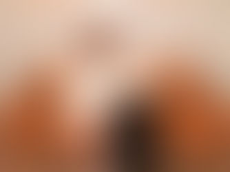 Two women sitting beside each other on a couch