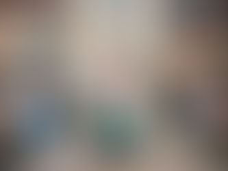 Bride in fairy wings walks down the aisle, pushing grandmother in a wheelchair, both smiling.