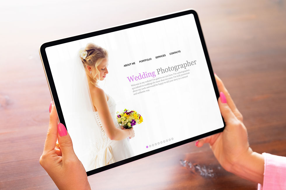 woman holds up a tablet, which displays the home page for a wedding photographer business