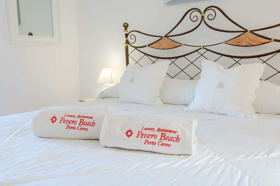 Luxurious bedroom with elegant white bedding at Villa Esmerea Porto Cervo