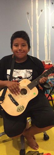 Lakota boy playing guitar