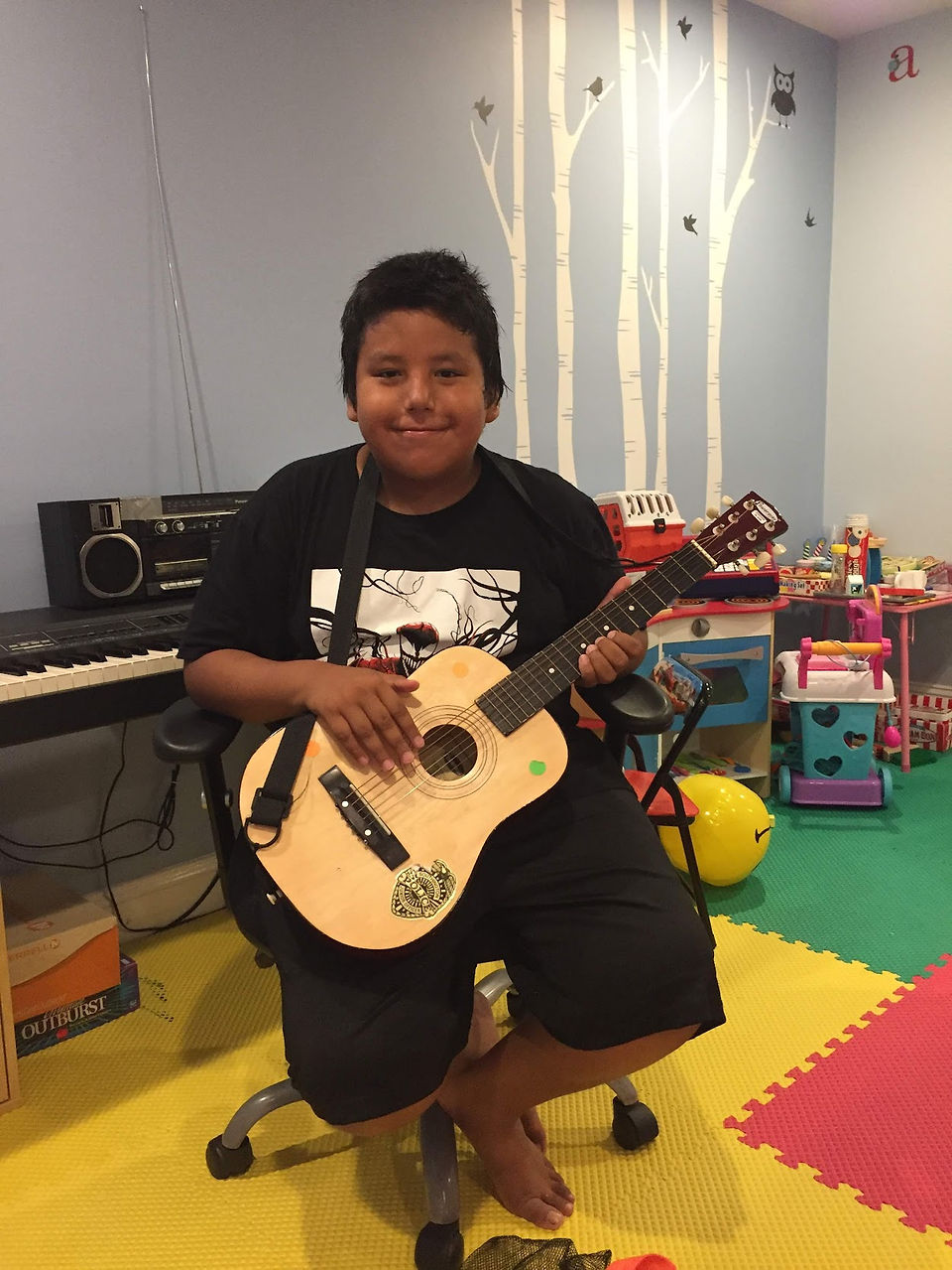 Lakota boy playing guitar