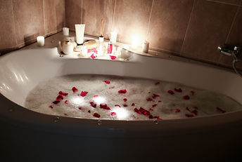 Butler Rose petal bath with candles