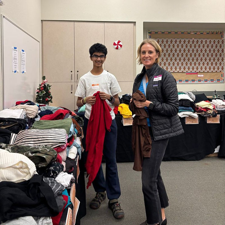 Andrea is pictured here volunteering at the 2025 Hands4Hope Winter Boutique, turning her dedication to Hands4Hope's mission into direct acts of service for those in need.