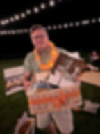 Chris Nicholson with a prize at the annual Hands4Hope Endless Summer Beach Party fundraiser