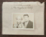 Older photo with a man in a suit and a woman in a floral dress on an envelope, handwritten address: Ella Hyer, Los Angeles. Brown table.
