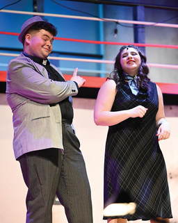 On stage, a man and woman captivate the audience in a scene from the musical "Anything Goes" at Greensburg Salem High School.