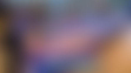 Inside Baxter’s R•Cade in Southpointe, two children stand at a "Classic Neon Bowling" arcade game in the foreground. In the background, another child plays on a long wooden shuffleboard table within the modern, well-lit entertainment venue and restaurant space.