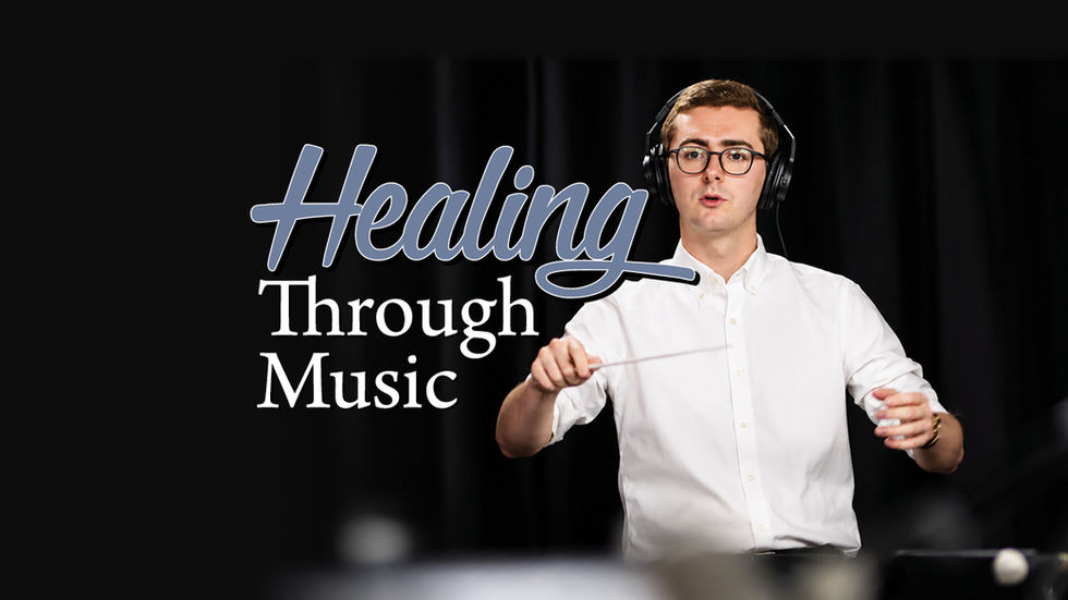 A promotional graphic against a solid black background. On the left, the words "Healing" in a large, blue-grey script font are positioned above "Through Music" in a white serif font. On the right, a young man with light brown hair, wearing wire-rimmed glasses and large black headphones, holds a baton and conducts with a focused expression, dressed in a white button-down shirt.