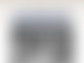 A celebratory graphic with a cream to light grey gradient background. At the top, there is a decorative border of various white balloons with strings. Centered below the balloons is the text "HAPPY BIRTHDAY MONROEVILLE!" in bold, dark blue capital letters, arranged on two lines. Below the text is a faded, black and white group photograph showing 13 people, mostly men in suits and one woman, seated and standing behind a long table with large floral arrangements.