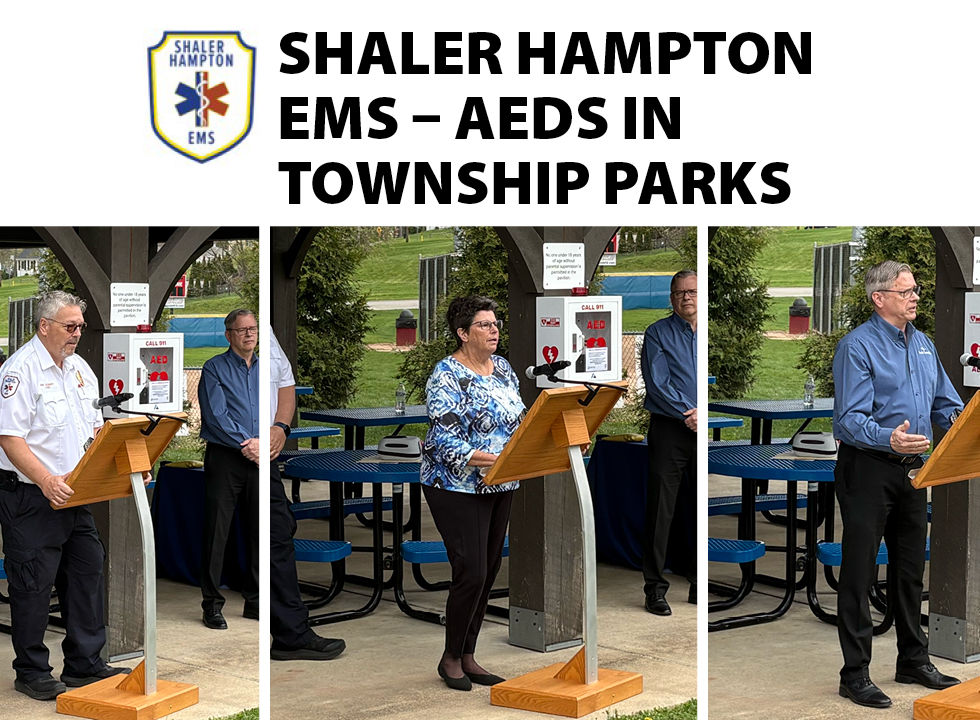 A graphic banner titled "SHALER HAMPTON EMS – AEDs IN TOWNSHIP PARKS" appearing next to the Shaler Hampton EMS logo. Below the text is a triptych of three people speaking at a wooden lectern under a park pavilion, with white, wall-mounted AED cabinets visible behind them.