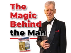 A professional feature graphic on a plain white background. On the right, a portrait-style photo of smiling magician Dan Kamin, with gray hair, wearing a black double-breasted tuxedo with a velvet lapel, a red pocket square, a white shirt, and a black bow tie. He is placing his right hand over his left jacket lapel. On the left, large text in bold red font reads "The Magic Behind." Below it, a black horizontal rule. Under the rule, text in a stylized black font with a red drop shadow reads "the Man." Below the red rule, a small graphic features a vintage-style comic book cover entitled "THE MAGIC LESSON with DAN KAMIN," featuring a young boy with card fans.