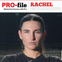 A professional "PRO-file" feature graphic for pickleball player Rachel Rohrabacher. The top third of the image contains the text "PRO-file" in large red and black letters, with the subtitle "Behind the Scenes with Pro RACHEL ROHRABACHER." The bottom two-thirds features a high-resolution, head-on studio portrait of Rachel Rohrabacher against a dark grey background, wearing a black athletic shirt.