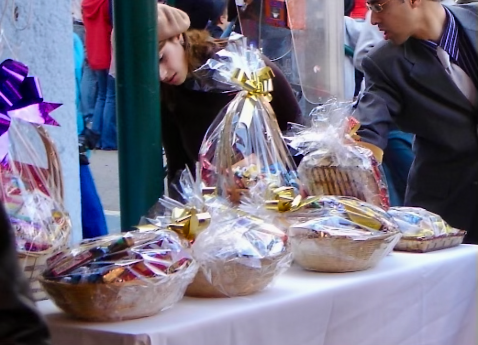 A beautiful table filled with traditional Mishloach Manot gift baskets and Oznei Haman and Hamantaschen cookies for Purim.