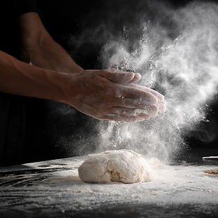 man-clapping-hands-sprinkling-flour-dough-black-background.jpg