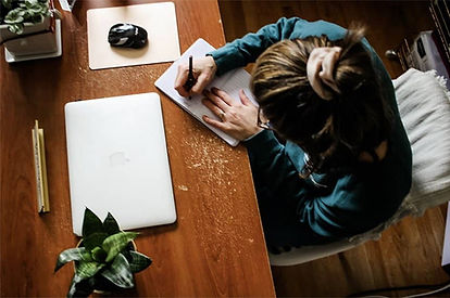 Woman writing at freshly organized desktop in Harrisburg, Pennsylvania