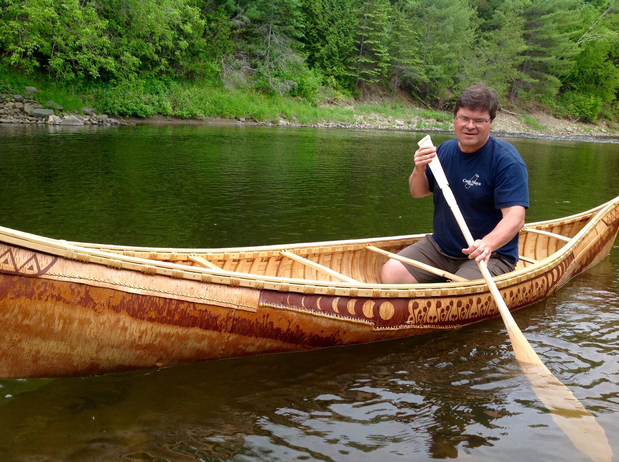 Enjoying the river in a birch bark