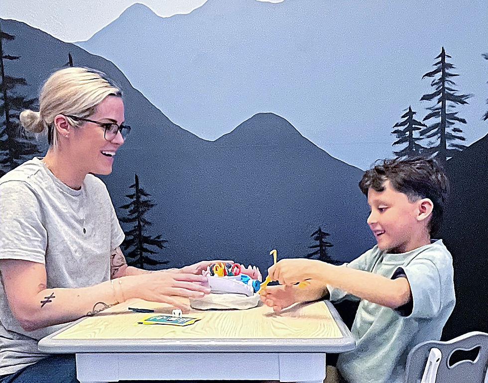 Speech therapist working with a child in a speech therapy session.