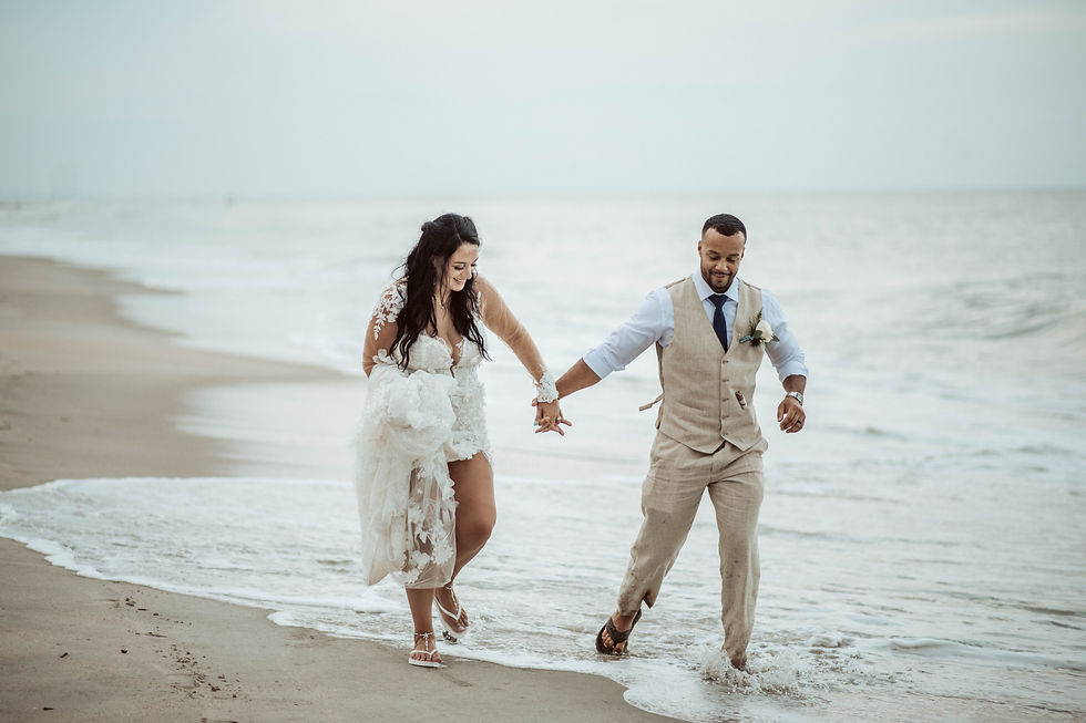 Bride and groom running on beach for elopement wedding