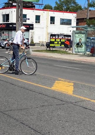 cyclist in traffic crossing bathurst.jpe