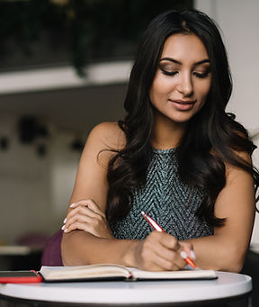 A Woman Sitting in a Coffee Shop and Wri