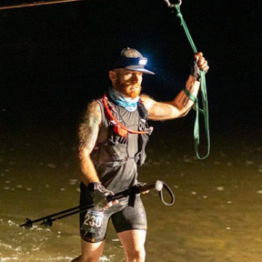 Justin doing a river crossing at night.