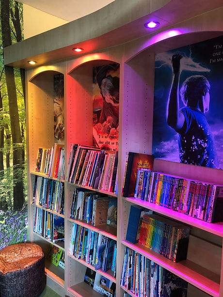 Library shelving for primary schools with coloured downlighter and images from popular children's books