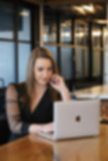 Woman works on laptop, reviewing health insurance solutions