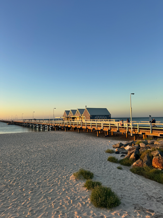 blaue kleine Häuschen an einem Steg bei Sonnenuntergang in Bussleton, Australien