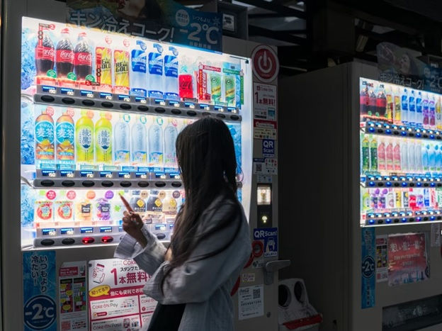 Woman selecting a drink from a modern vending machine