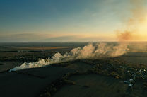 Aerial view of a firefighters truck extinguishing a fire caused by illegal burning of garb