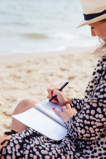 Karen writing on the beach