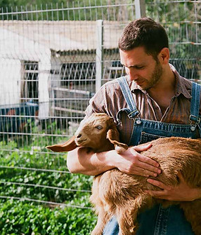 Farmer Holding Goat 