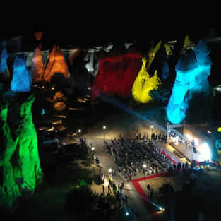 Outdoor event at night with colorful projection mapping.