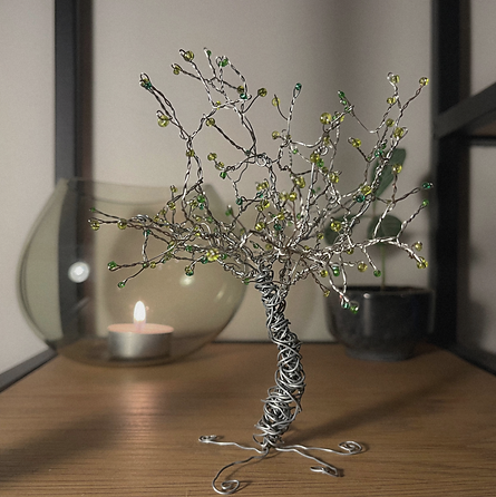 Environmental image of tree steel wire in shelf. With light and plant in the background