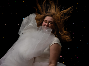 girl in white dress floating and smiling with sparkled on black background